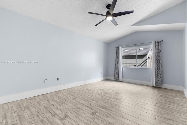 unfurnished room with a textured ceiling, ceiling fan, vaulted ceiling, and light hardwood / wood-style floors