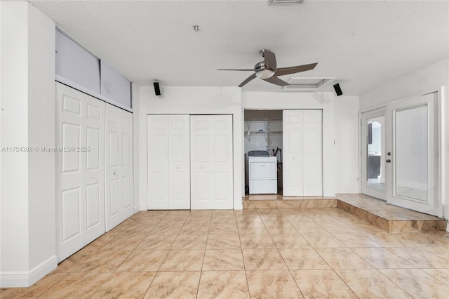 unfurnished bedroom featuring washer / clothes dryer, multiple closets, ceiling fan, and a textured ceiling