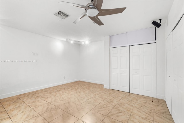 unfurnished bedroom with ceiling fan and a closet