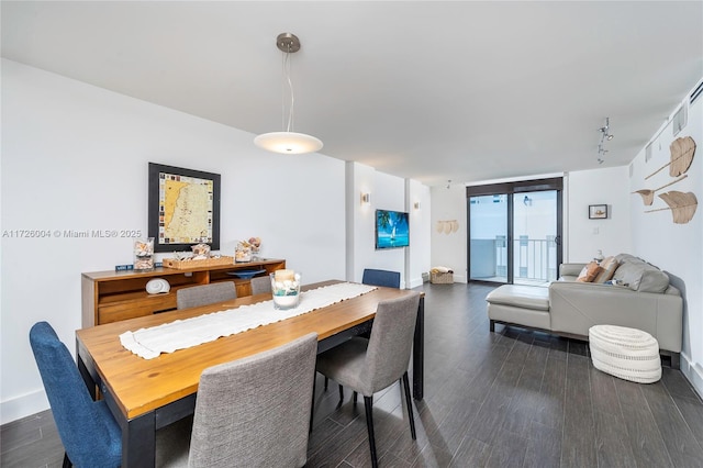 dining space with floor to ceiling windows and dark hardwood / wood-style flooring