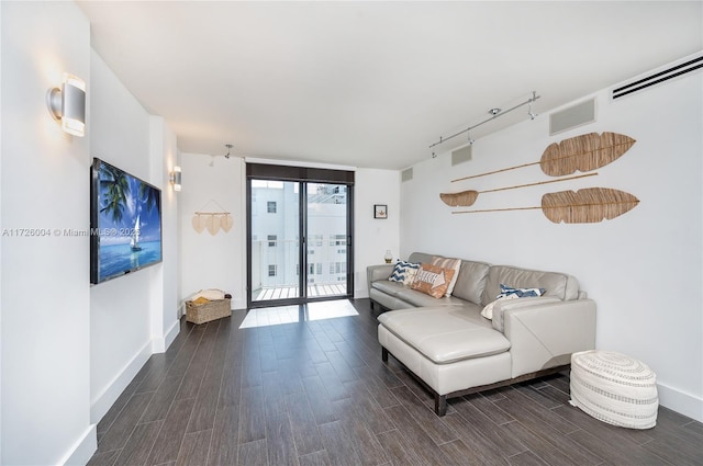 living room with track lighting and a wall of windows