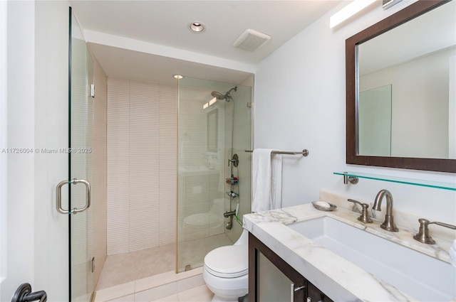 bathroom with walk in shower, tile patterned flooring, vanity, and toilet