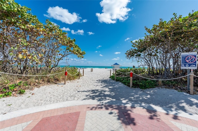 view of community with volleyball court and a water view