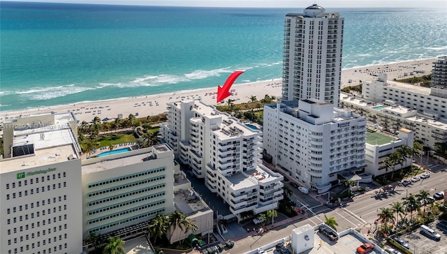 birds eye view of property with a beach view and a water view