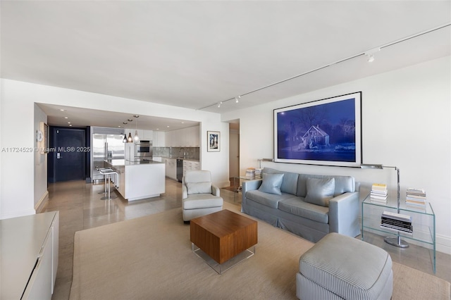 living room with rail lighting and light tile patterned floors