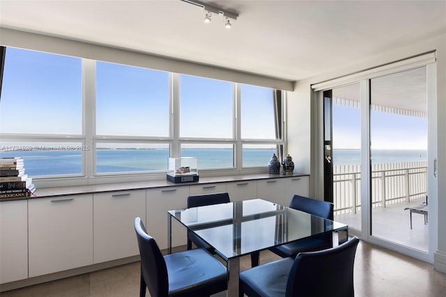 dining space with a view of the beach and a water view