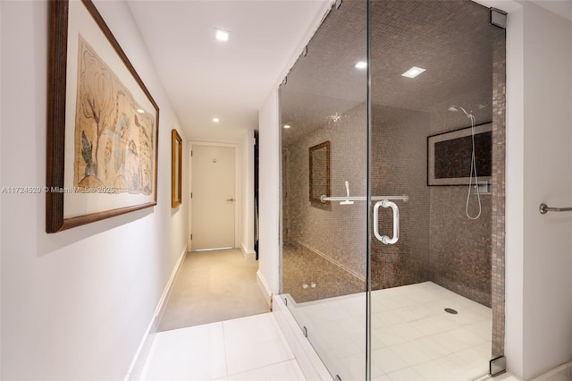 bathroom featuring a shower with door and tile patterned flooring