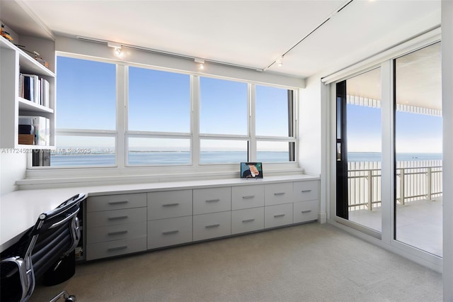 interior space featuring a view of the beach and a water view