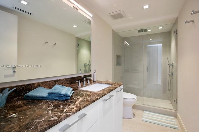 bathroom with walk in shower, vanity, and toilet