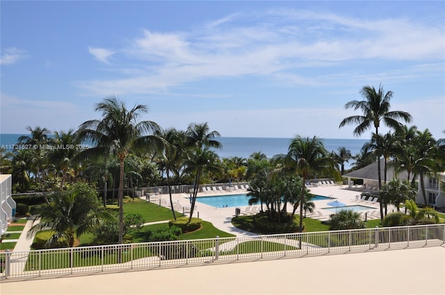 view of pool with a patio area and a water view