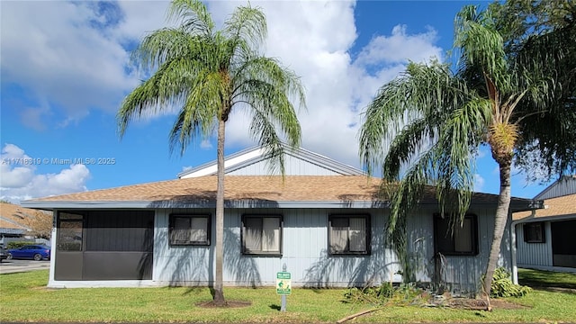 view of side of property with a lawn