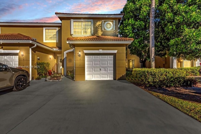 mediterranean / spanish house with a garage