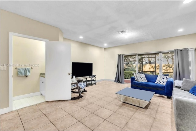 tiled living room with a textured ceiling