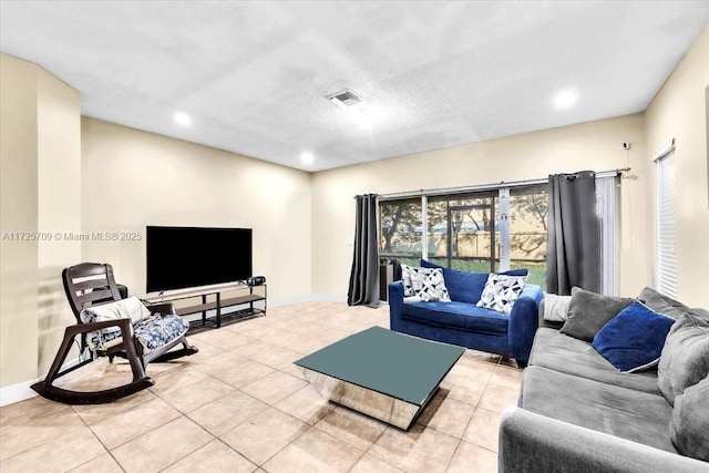 living room featuring a textured ceiling and light tile patterned flooring