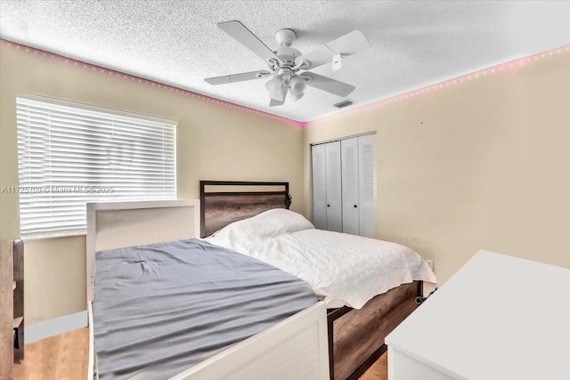 bedroom featuring a closet, ceiling fan, and a textured ceiling