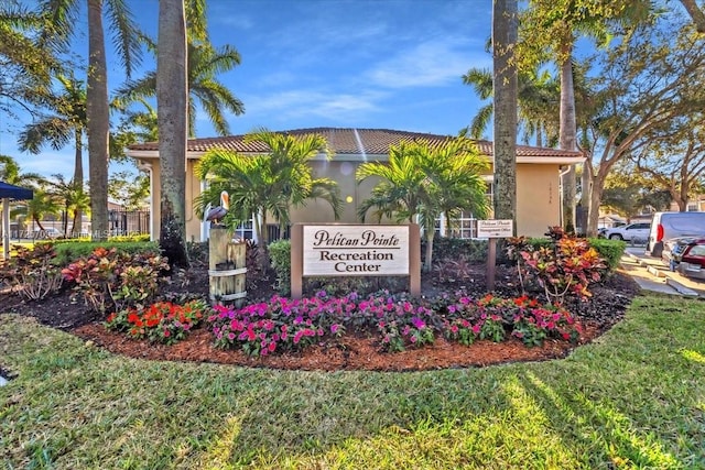 community sign featuring a lawn