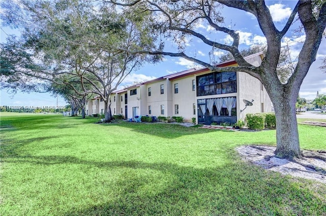 back of property featuring a yard