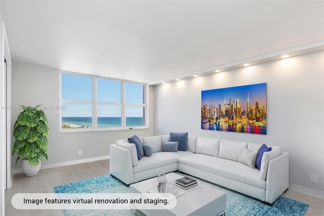 living room with light hardwood / wood-style flooring and a water view