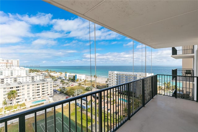 balcony with a beach view and a water view