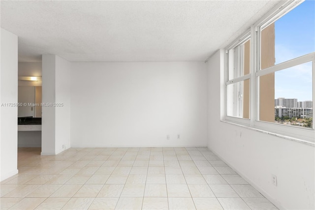 unfurnished room featuring a textured ceiling