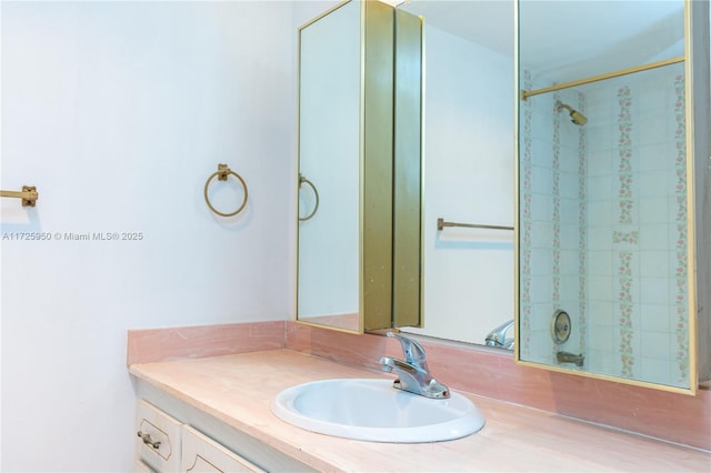 bathroom with a shower and vanity