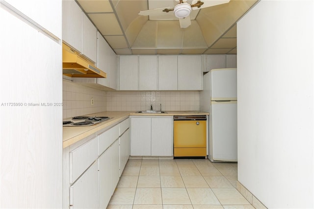 kitchen with dishwashing machine, stainless steel gas cooktop, white cabinets, white refrigerator, and sink