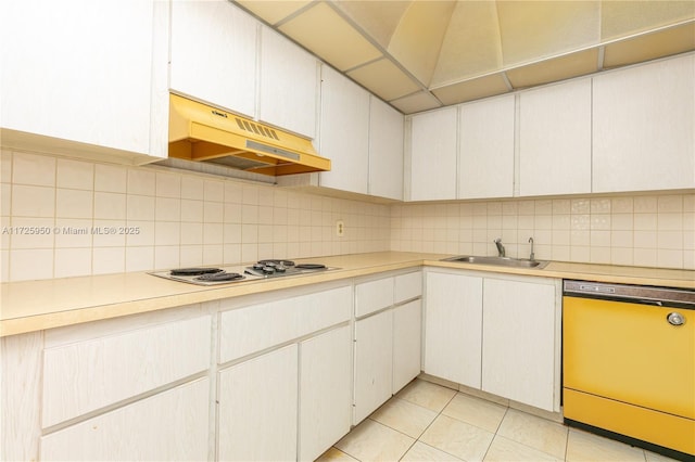 kitchen featuring sink, white stovetop, dishwasher, and white cabinetry