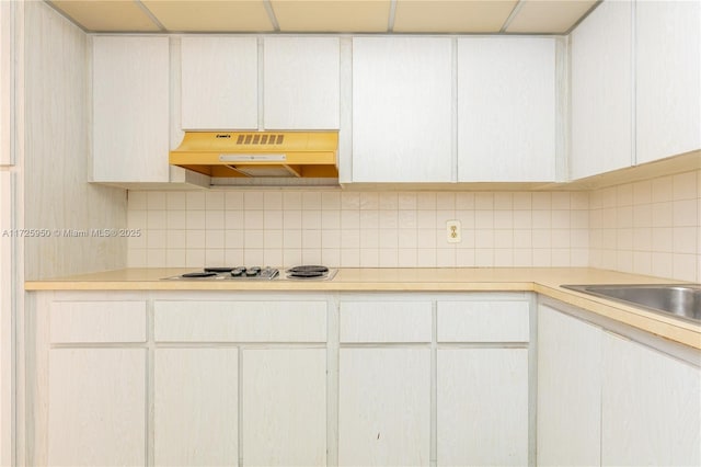 kitchen featuring white cabinetry, extractor fan, backsplash, and gas stovetop