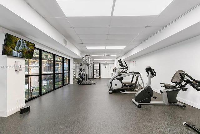 gym with a paneled ceiling