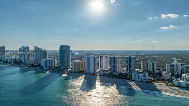 drone / aerial view featuring a beach view and a water view