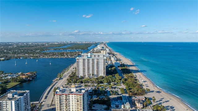 birds eye view of property featuring a beach view and a water view