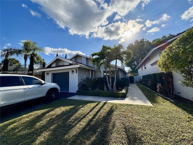 view of front of property featuring a garage and a front yard