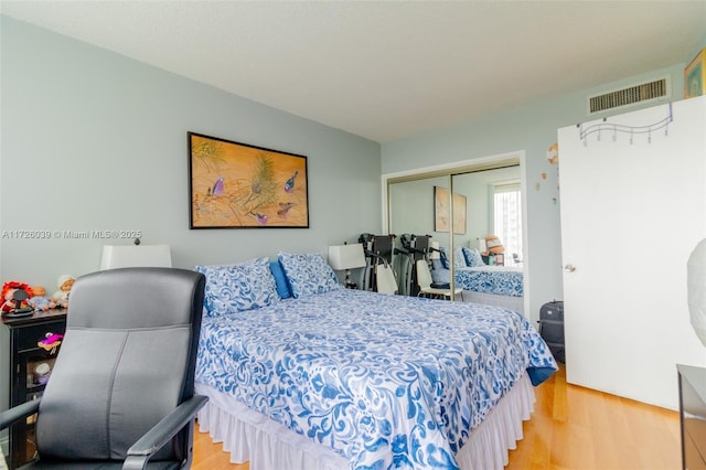 bedroom with a closet and hardwood / wood-style floors