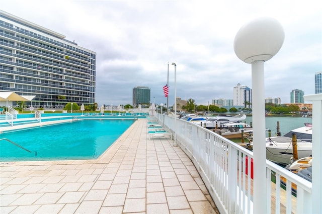 view of swimming pool featuring a water view