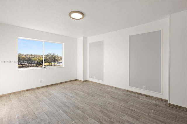 empty room featuring wood-type flooring