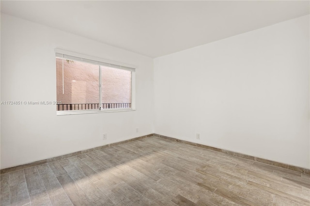 unfurnished room with light hardwood / wood-style flooring