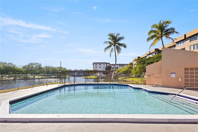 view of swimming pool with a water view