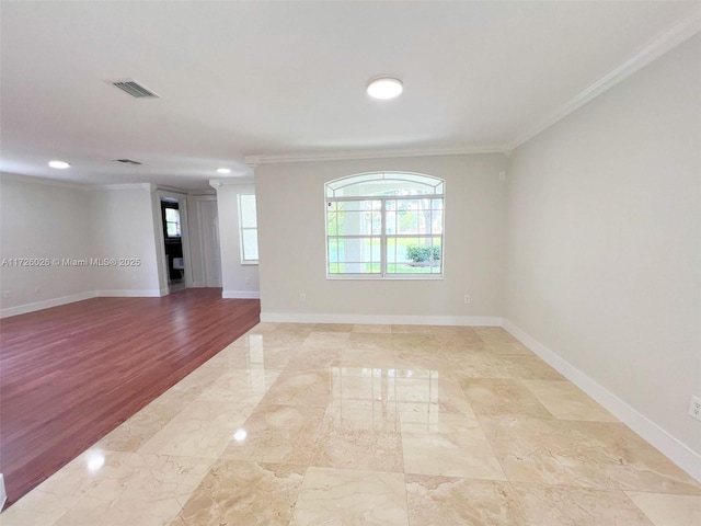 unfurnished room with crown molding