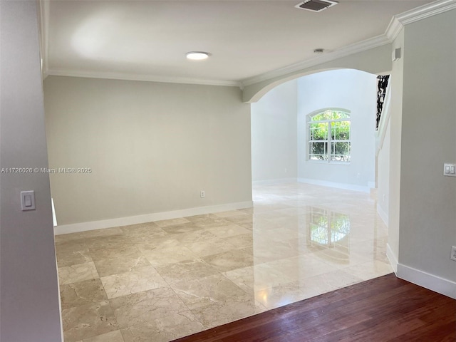 spare room featuring crown molding