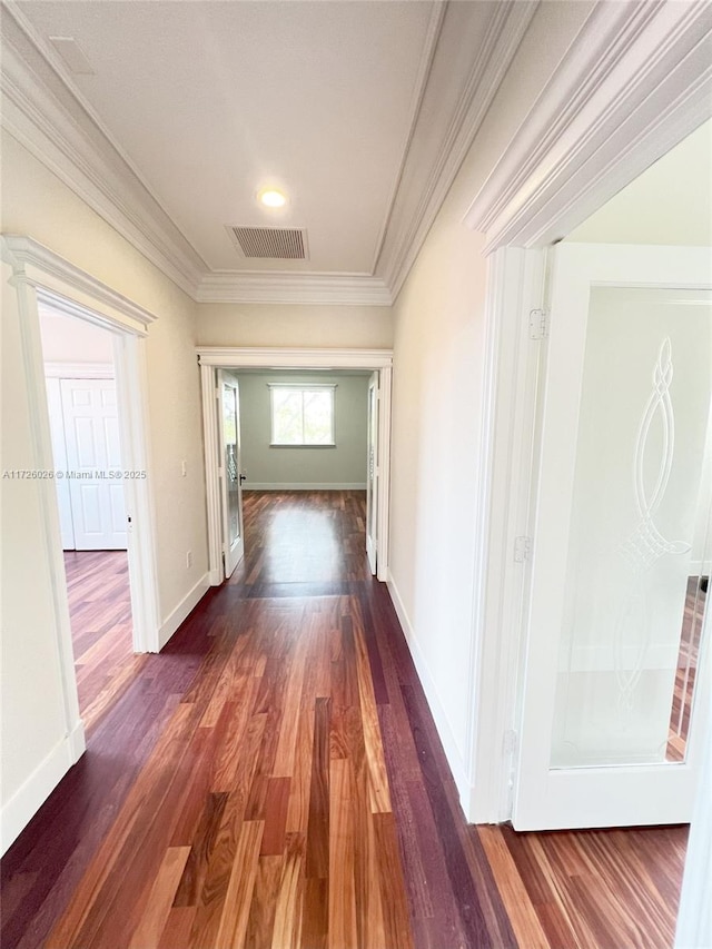 corridor featuring crown molding and dark hardwood / wood-style flooring