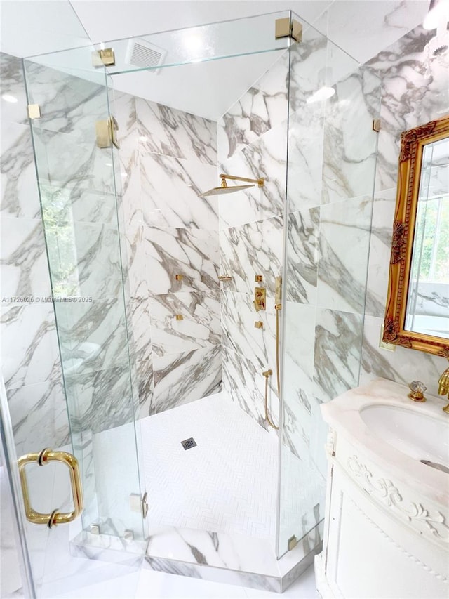 bathroom featuring an enclosed shower and vanity