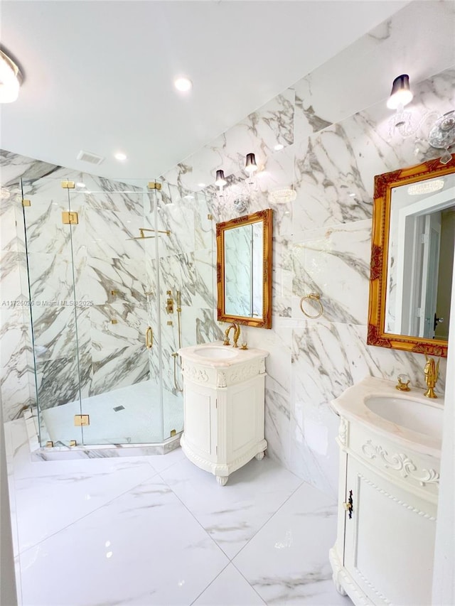 bathroom with vanity, tile walls, and a shower with shower door