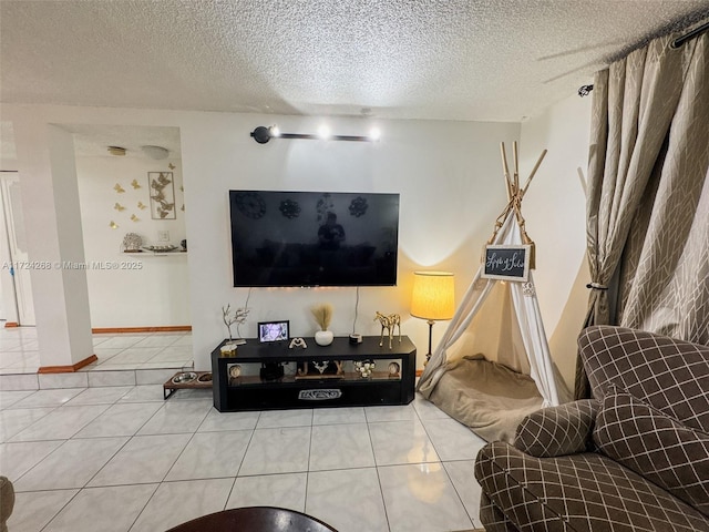 tiled living room featuring a textured ceiling