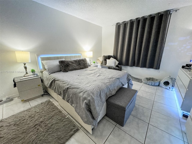 bedroom featuring a textured ceiling and light tile patterned flooring