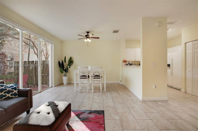 unfurnished living room with ceiling fan