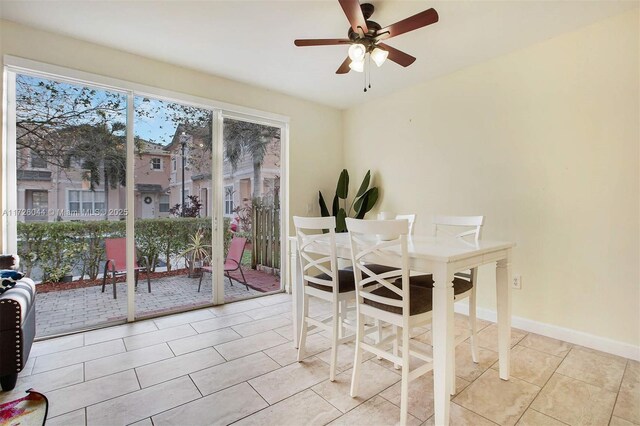 tiled dining space featuring ceiling fan