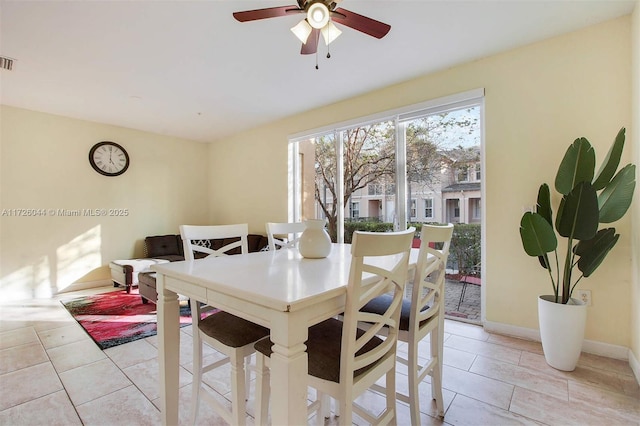 dining area featuring ceiling fan and light tile patterned floors