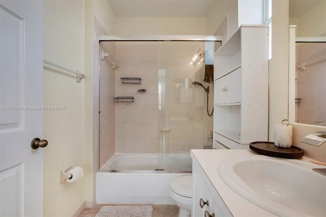 full bathroom featuring enclosed tub / shower combo, vanity, toilet, and tile patterned flooring