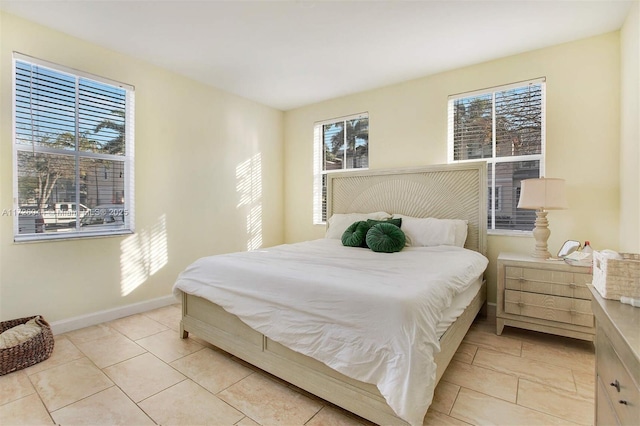 tiled bedroom featuring multiple windows