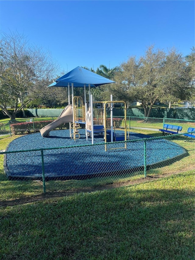 view of jungle gym featuring a lawn